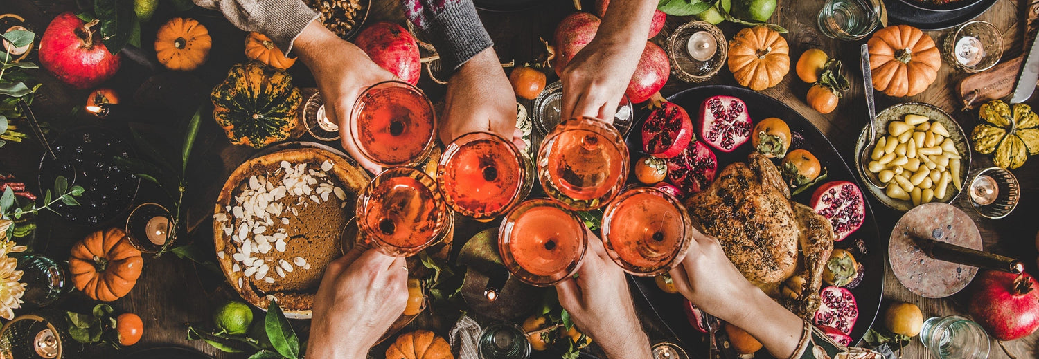 Family enjoying Thanksgiving dinner at a table outdoors