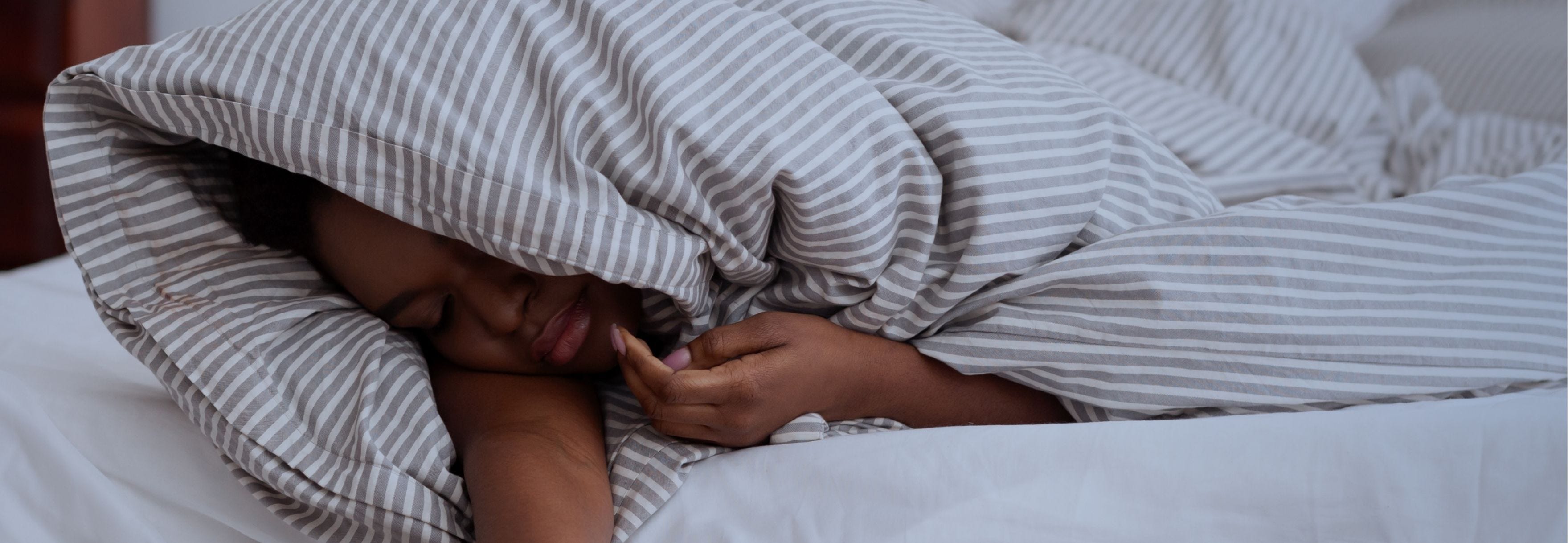 person laying uncomfortably in bed
