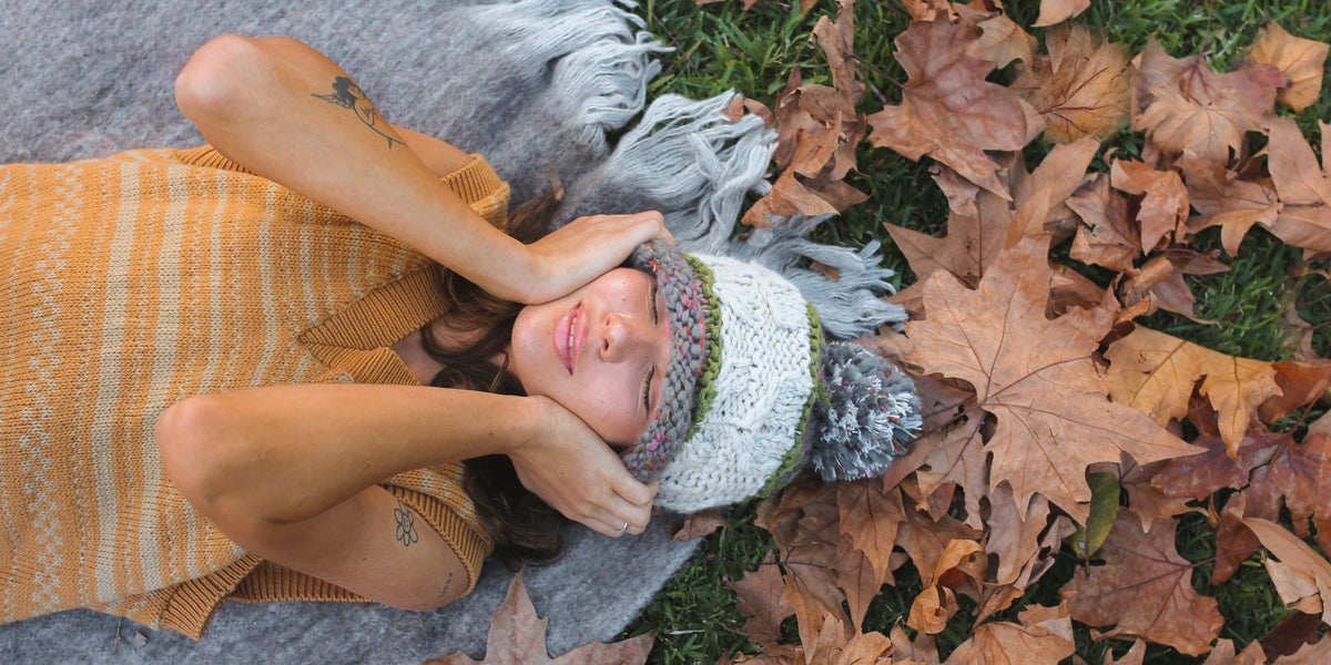woman sleeping outside in a pile of fall leaves
