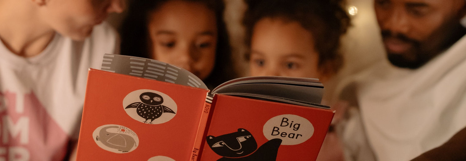 family reading bedtime stories to children