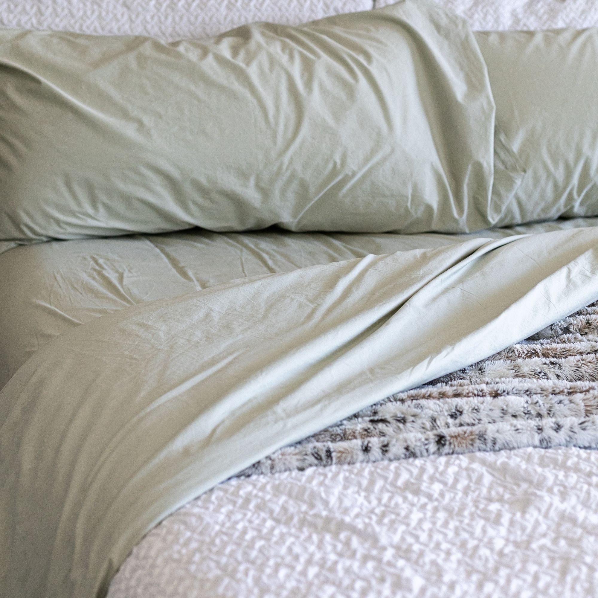 Beige pillow and blanket on a bed
