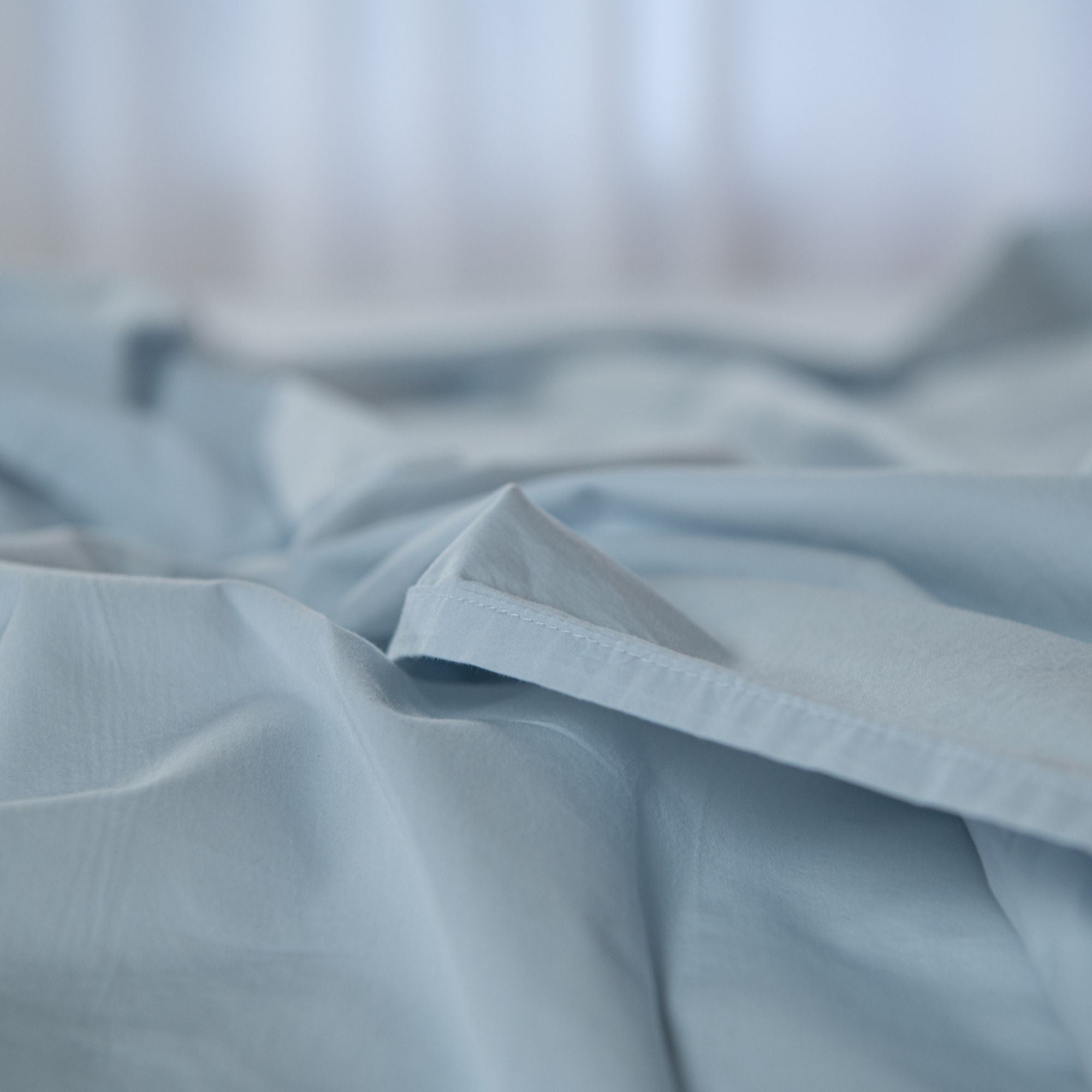 Close-up of light blue fabric with a blurred background