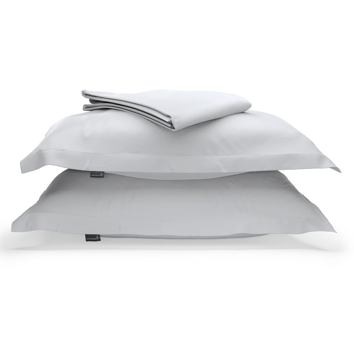 A duvet cover folded on top of two pillow shams against a white background #color_mist