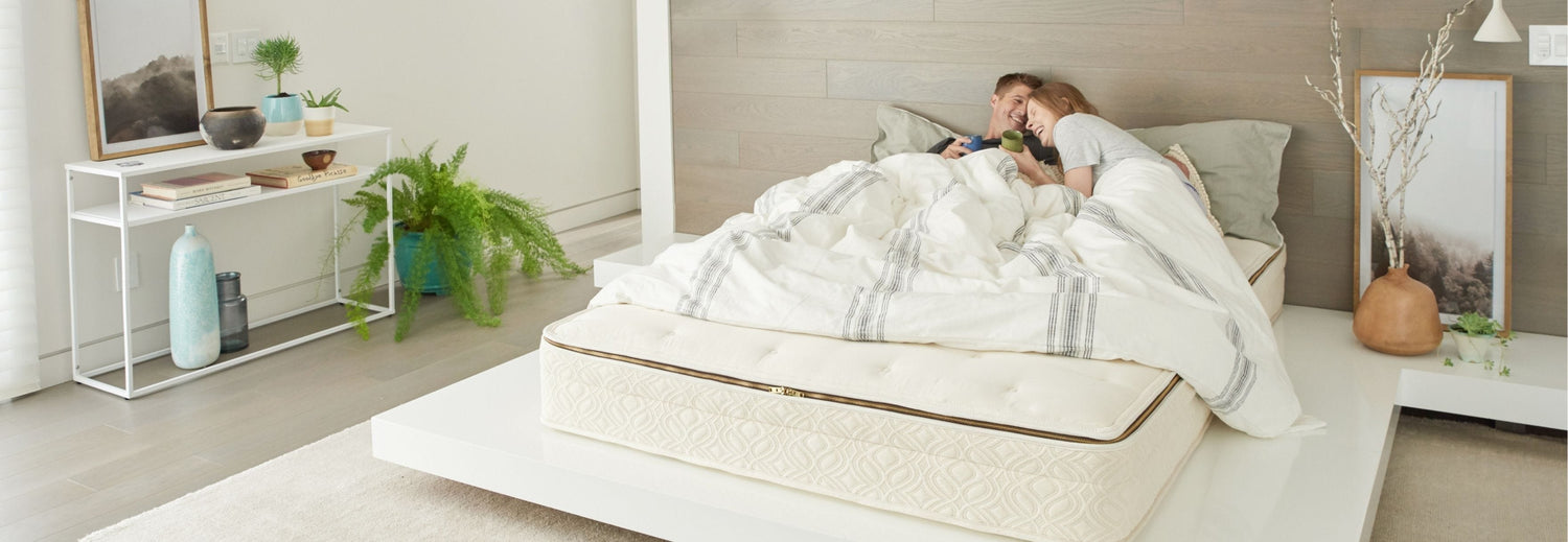 couple laying on an expensive organic mattress