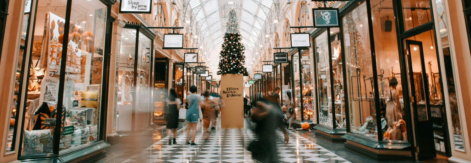 holiday market with shoppers and Christmas tree