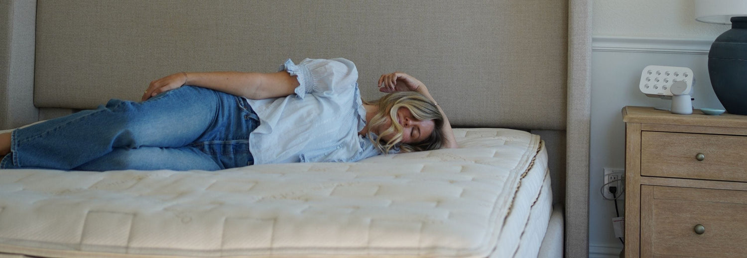 woman laying on her side on a mattress