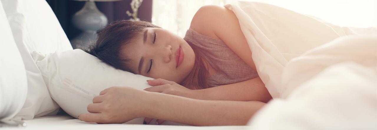 Woman sleeping peacefully in her bed