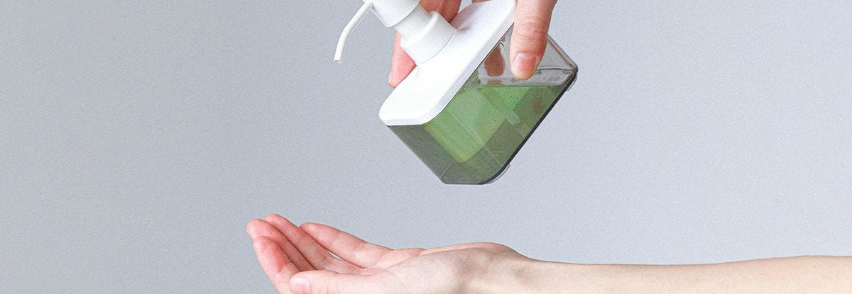 Green soap being pumped into hand