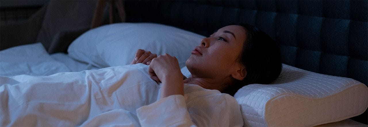 Woman lying awake in bed who cant sleep