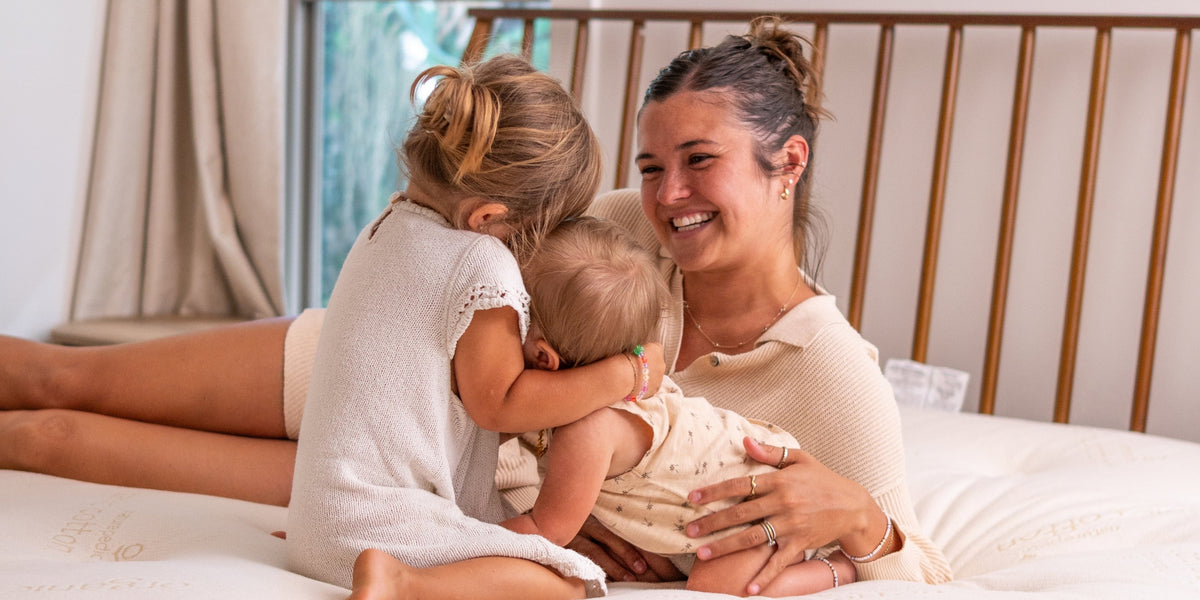 woman and children all on one mattress