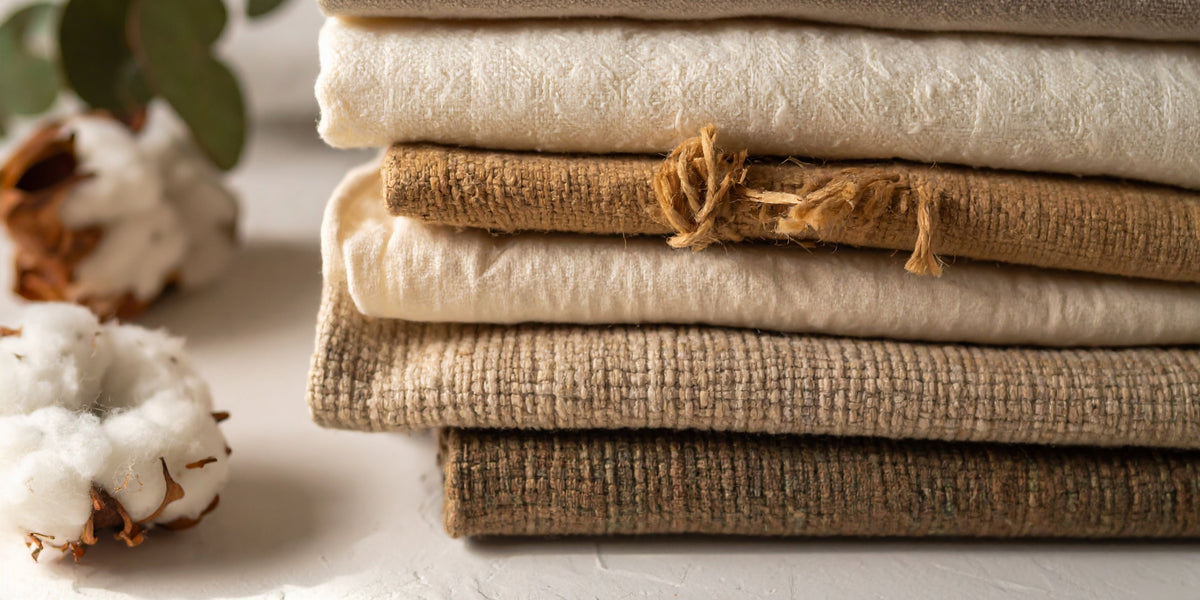 organic cotton textiles next to boll of organic cotton