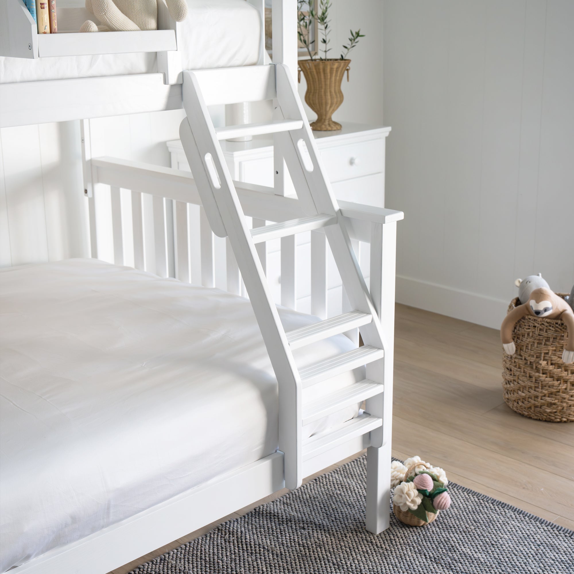 White bunk bed with a ladder in a room setting. #color_washed white  #size_Twin/Full Bunk 