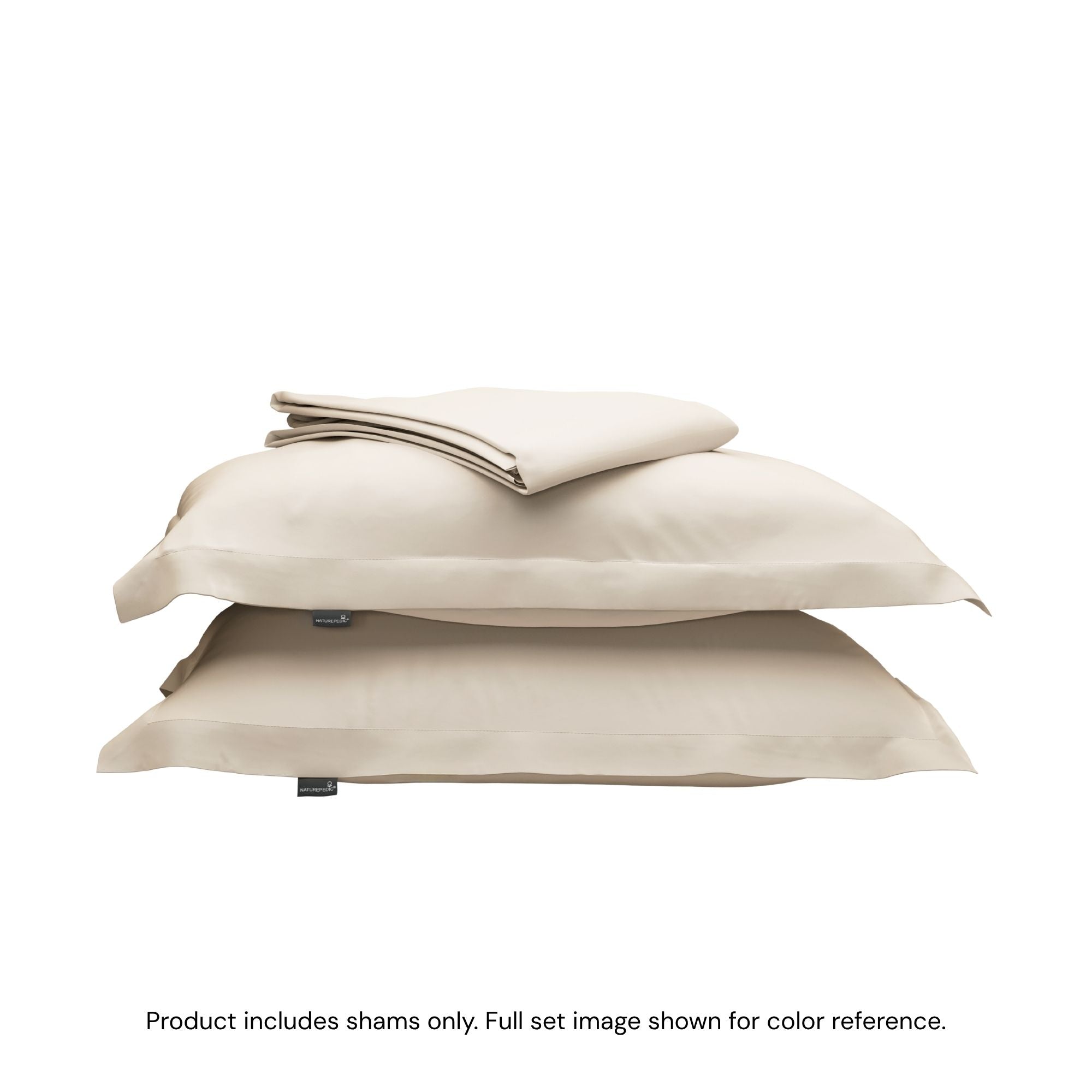 A folded duvet cover on top of two pillow shams. #color_cream