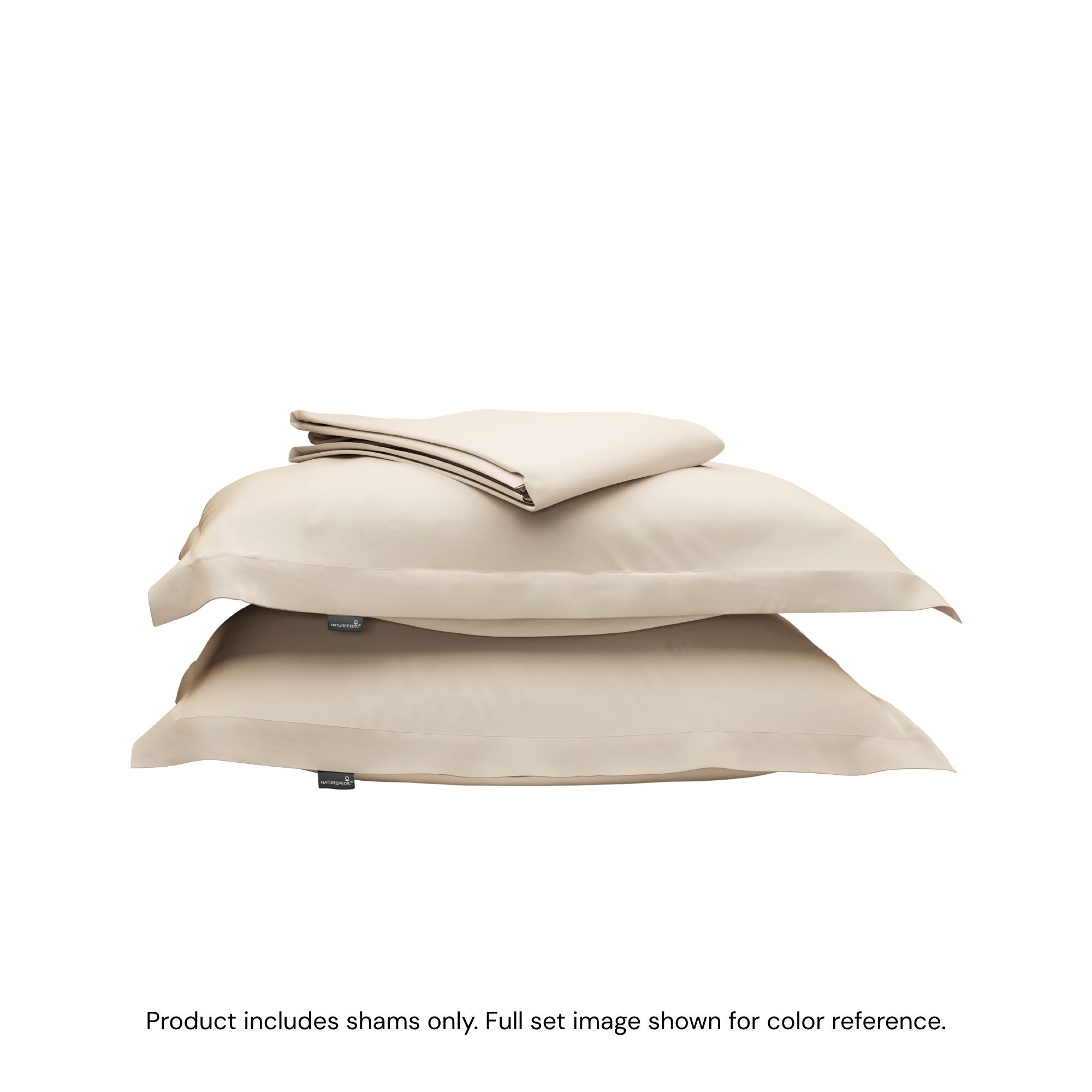 A folded duvet cover on top of two pillow shams. #color_undyed