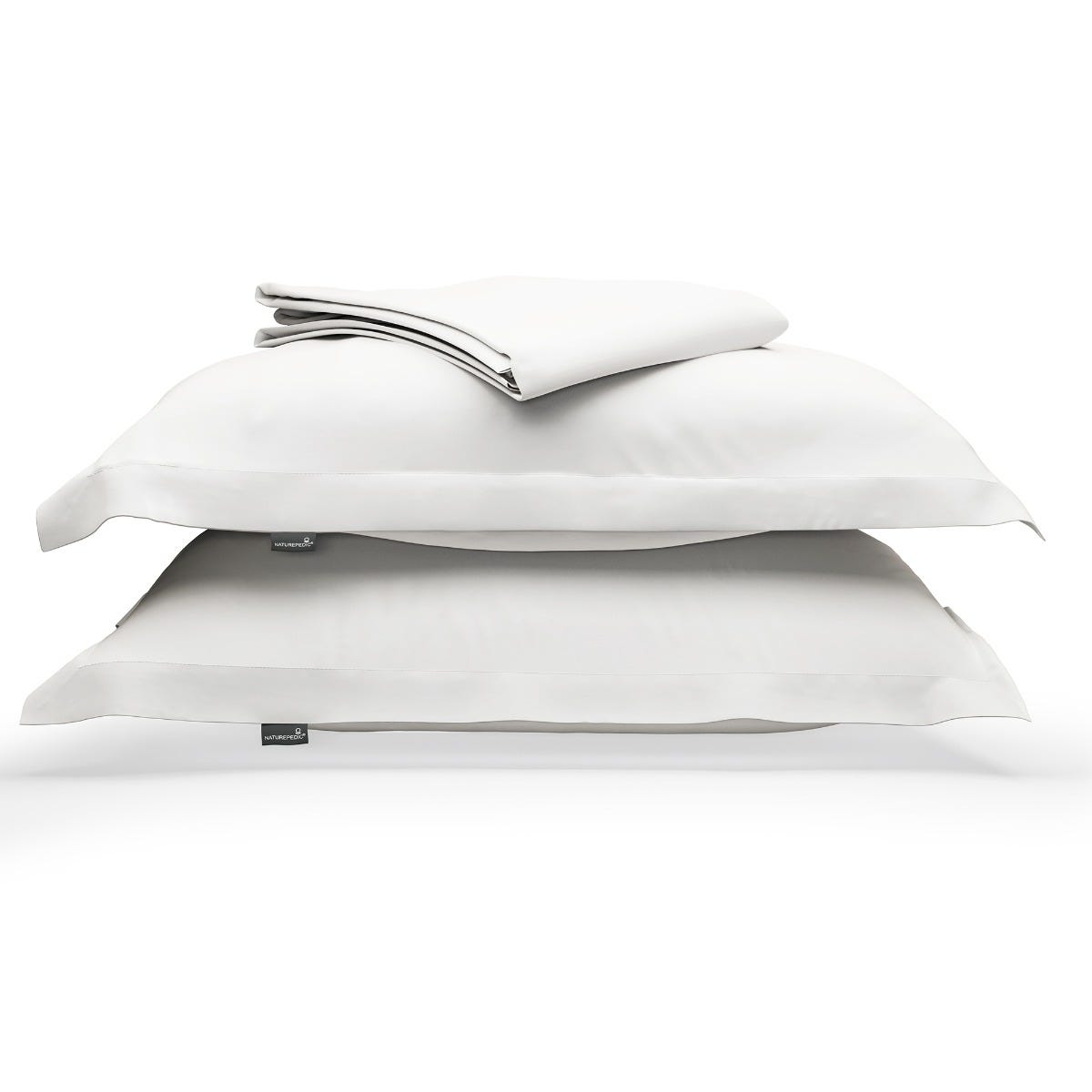 White duvet cover folded on top of two matching shams against a white background #color_arctic snow