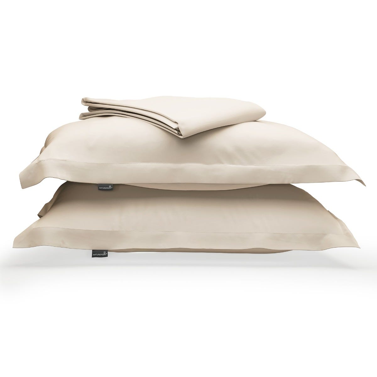 Cream duvet cover folded on top of two matching shams against a white background #color_cream