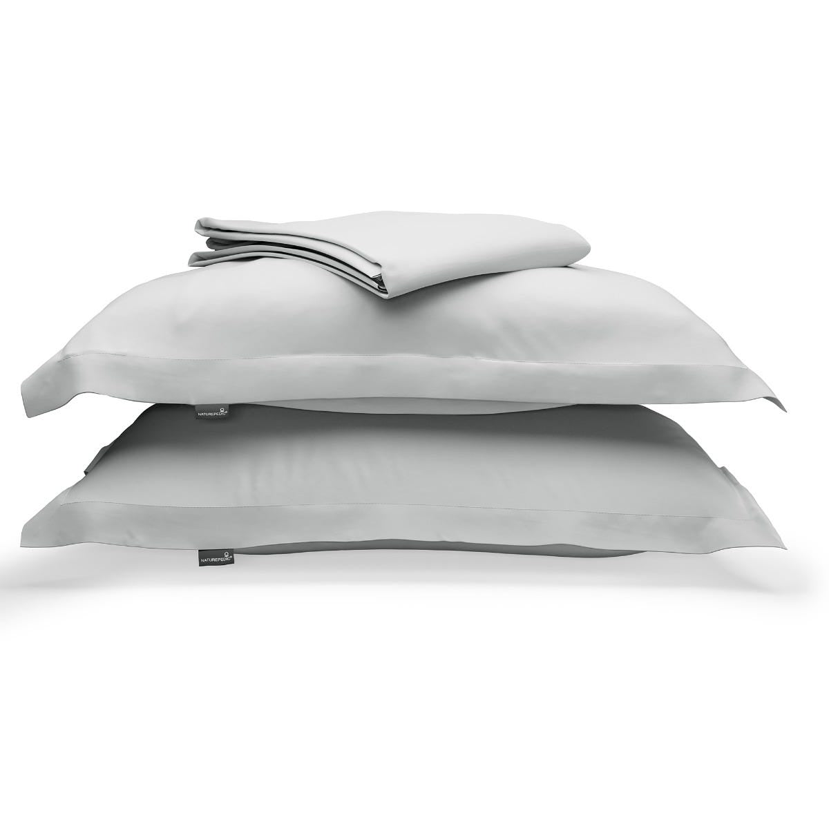 Light grey duvet cover folded on top of two matching shams against a white background #color_mist