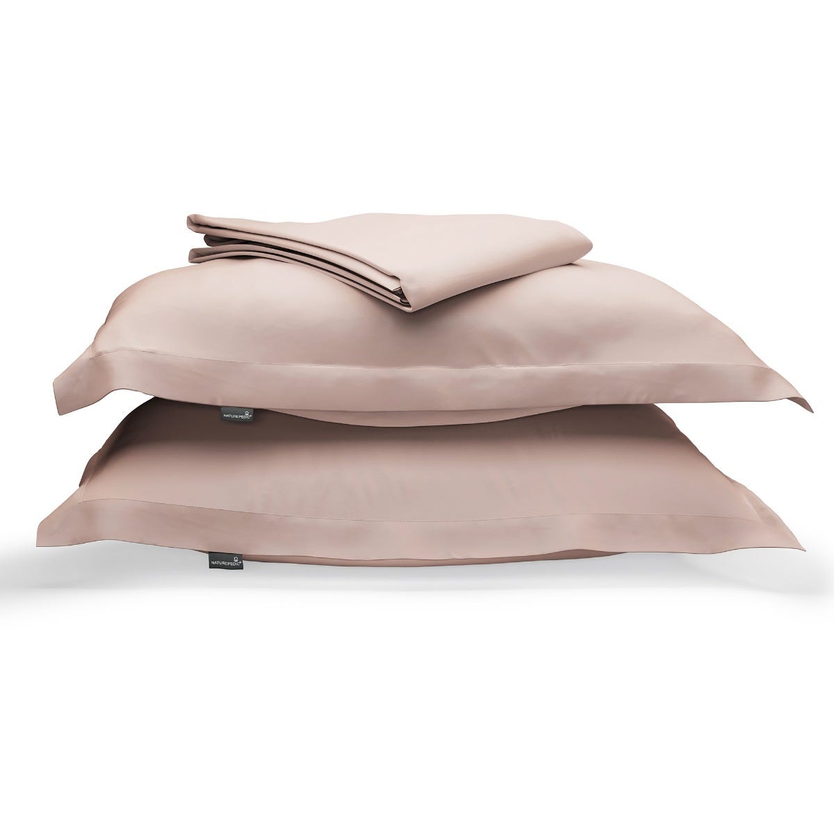 Soft pink duvet cover folded on top of two matching shams against a white background #color_petal