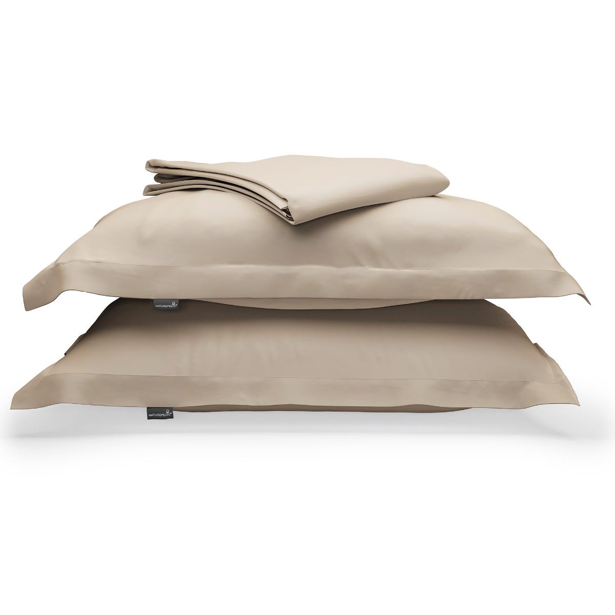 Beige duvet cover folded on top of two matching shams against a white background #color_sand