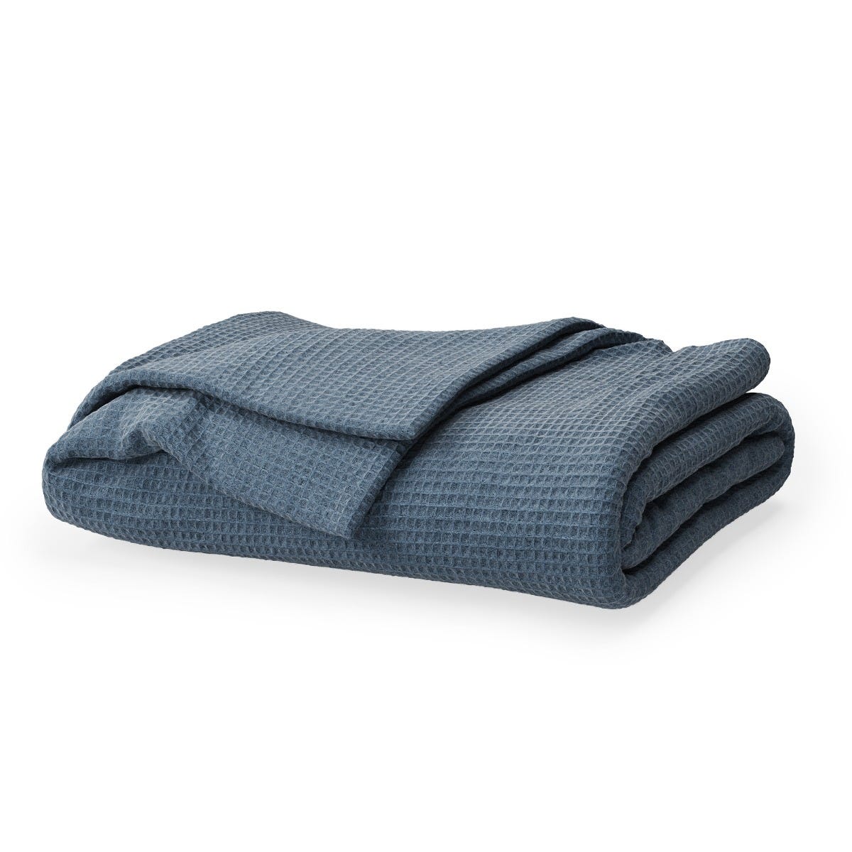 Folded blue textured blanket on a white background #color_mineral blue