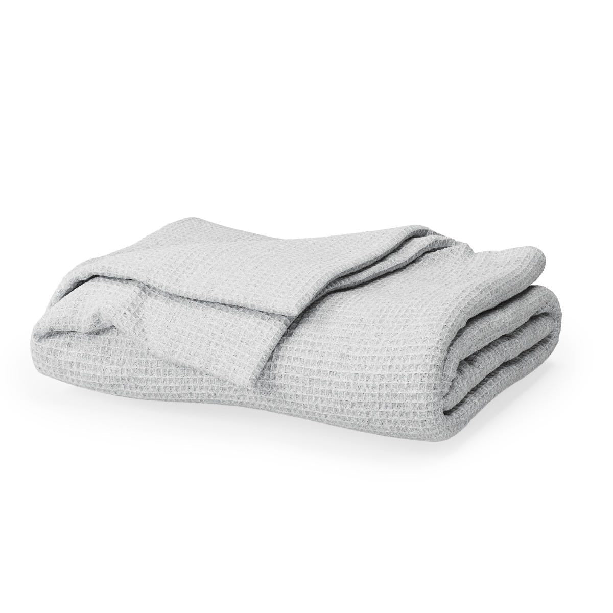 Folded gray blanket on a white background #color_mist