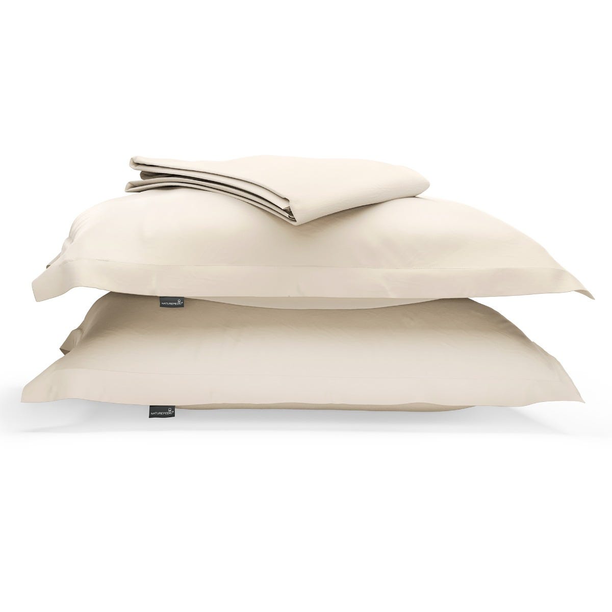 A duvet cover folded on top of two pillow shams against a white background #color_cream