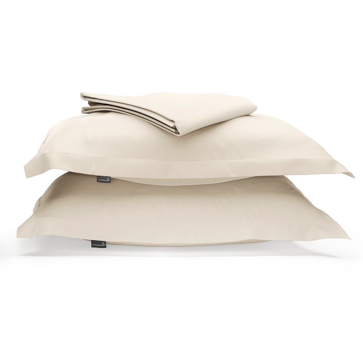 A duvet cover folded on top of two pillow shams against a white background #color_undyed